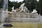 Large fountain with many statues, in white marble, with the figure of Neptune, at the top of the park, of the Belvedere castle in