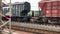 Large freight green and brown train wagons move back