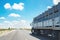 Large freight truck on highway with blue sky.