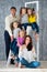 Large friendly family, many children: dad mom and four pretty cheerful girls triple twins sisters sitting on stepladder near