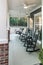 A large front porch of a traditional new construction gray house with rocking chairs