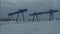 Large gantry cranes in the idustrial zone during working process, time lapse. Cargo cranes near storehouses in the