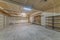 Large garage interior with wall filler white markings and shelves