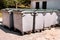 Large garbage containers, trash dumpsters and bins standing in row. Orderly stowed garbage cans.