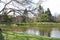 Large garden lake pond surrounded by trees and green grass