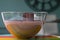 Large glass bowl of chocolate mousse standing on colourful glass platter, decorated with chocolate shavings and curls.