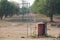 A large, gold-plated, old-fashioned water tank in the garden for watering plants.