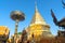 Large golden chedi surrounded by Buddhist architectural structur