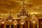 Large Golden vintage crystal chandeliers on the ceiling in the rich hall