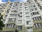 Large gray panel house with windows and balconies. Multi-storey residential building, new building. The background. Texture