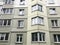 Large gray panel house with windows and balconies. Multi-storey residential building, new building. The background. Texture