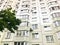 Large gray panel house with windows and balconies. Multi-storey residential building, new building. The background. Texture