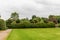 Large green landscaped hedge with ball shapes on top in Crathes Castle gardens, Scotland