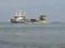 A large grey hopper dredger at the westerschelde in holland