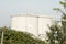 Large grey industrial tanks for petrol and oil storage