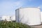 Large grey industrial tanks for petrol and oil storage