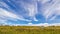 a large group of ATVs stand in the background against the blue sky on a summer sunny day. Russian fans of pokatushek gathered in