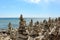 A large group of cairns in front of a vast expanse of Lake Michigan in Door County, Wisconsin