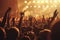 A large group of concert-goers enthusiastically raise their hands while enjoying a live performance, An energetic scene from a