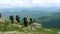 Large group of happy hiker tourists with large sports backpacks on top of the mountain. Active life concept. Carpathians