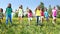 Large group of kids run in dandelion field