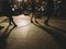 Large group of pedestrians silhouettes Christmas Market in front of fir tree seller