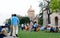 Large group of tourists people sitting on the lawn area and spending Holiday time in sunset time. Beluá¹› Maá¹­h Ramakrishna Swami