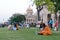 Large group of tourists people sitting on the lawn area and spending Holiday time in sunset time. Beluá¹› Maá¹­h Ramakrishna Swami