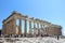 A large group of visitors admiring the Parthenon atop the Acropolis on a hot sunny day during a summer day in Athens