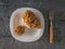 Large gyromitra mushrooms in a white plate on a wooden background.