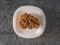 Large gyromitra in a white plate on a wooden background