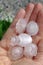 Large hailstones in the hand of a woman