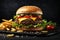 Large hamburger and fries on dark background