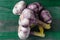 Large heads of fresh garlic on a green wooden background