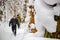 Large heaps of snow in nature and a group of tourists in the distance