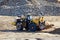 Large heavy front-end loader or all-wheel bulldozer for mechanization of loading, digging and excavation operations in open quarry