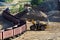 Large heavy front-end loader loading sand it to the freight train. Heavy mining work in a quarry