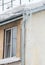Large ice icicles hang from the drainpipe at the edge of the roof.