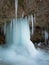 Large ice pillar stands in a cave