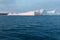 Large iceberg and boat in the Disko Bay, Greenland. The source of these icebergs is the Jakobshavn glacier.