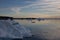 A large iceberg in the foreground with many icebergs in the background at sunset in northwest Greenland