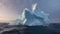 A large iceberg in a stormy ocean with splashes against a dark overcast sky.