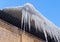 Large icicles hanging on the roof of the house