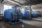 large industrial boiler room and water treatment facility. blue pumps, shiny stainless metal pipes