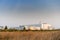 Large industrial factory building in the middle of the field on beautiful sunshine and blue sky at sunset of evening day