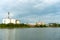 Large industrial factory and silo building at side coast of sea in evening with cloudy sky