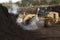 large industrial machinery being used at a garbage dump