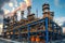 Large industrial oil refinery with pipes and distillation columns at sunset under a moody sky