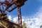 Large industrial structure against a vivid blue sky on a crisp fall morning