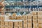 Large industrial warehouse with high racks. In the foreground are a lot of cardboard boxes.